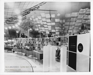 Photograph of the Ready Reference Center shows the reference books arranged on shelves in a half circle behind a series of low desks.