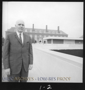 Photograph from the University of Illinois Archives of Robert Downs standing outside the Main Library and Undergraduate Library